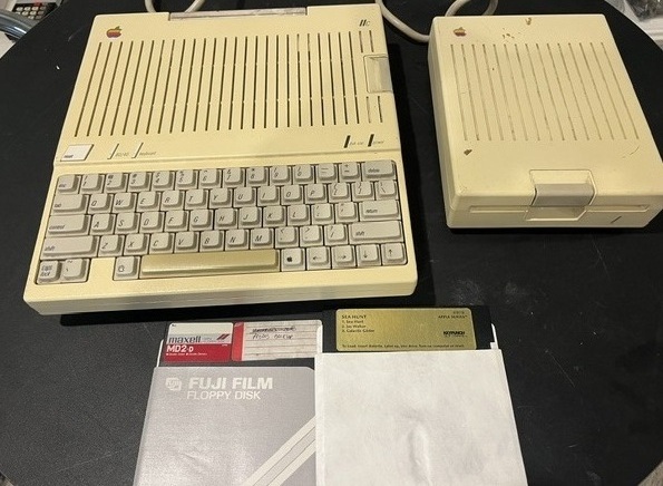 Apple IIc with external disk drive and floppy disks