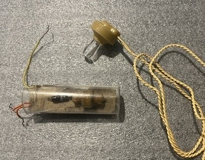 First crystal radio in a pill bottle with crystal earpiece